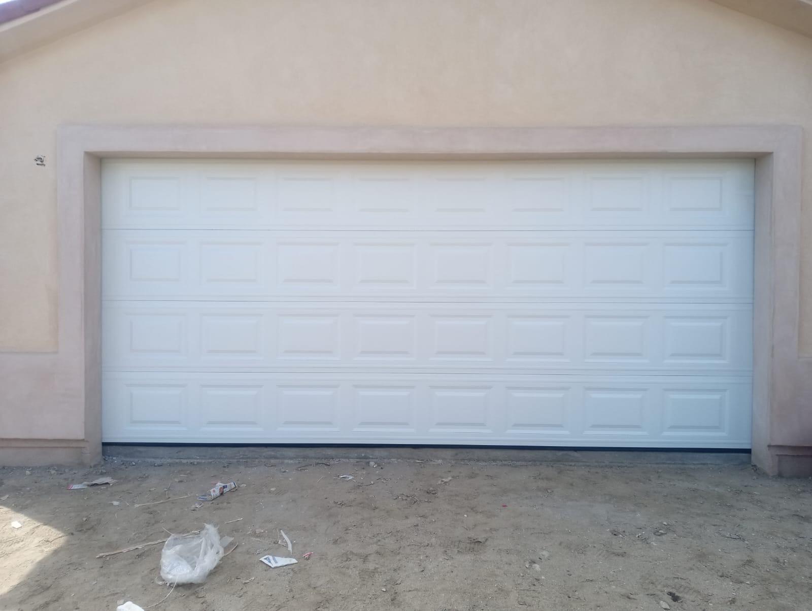 Newly installed white long-panel steel garage door in Coachella