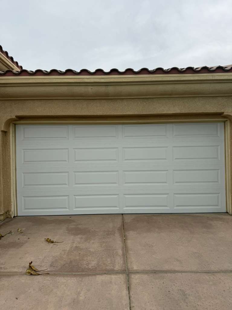 White raised-panel steel garage door installation in Beaumont